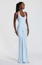 Woman wearing a light blue evening gown against a white background
