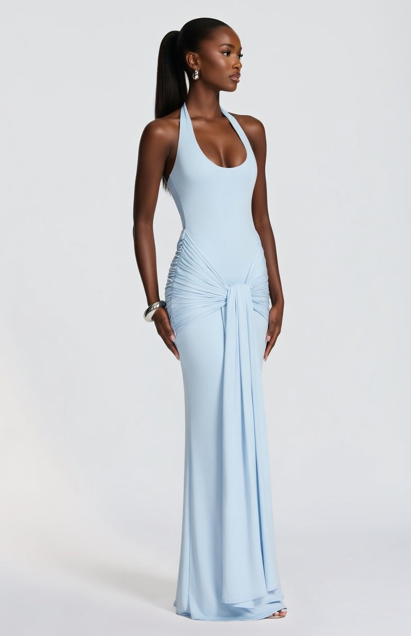 Woman wearing a light blue evening gown against a white background