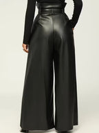 Black wide-leg pants worn by a person on a light beige background