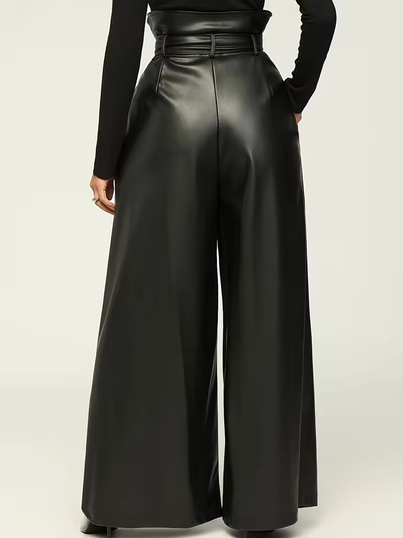 Black wide-leg pants worn by a person on a light beige background
