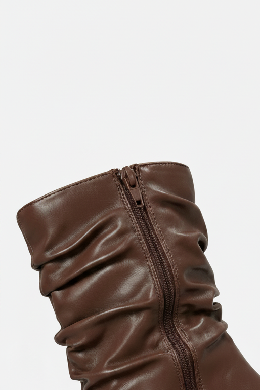 Brown leather boot with a zipper on a light gray background