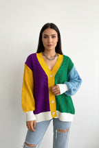 Person wearing a colorful cardigan with a white background