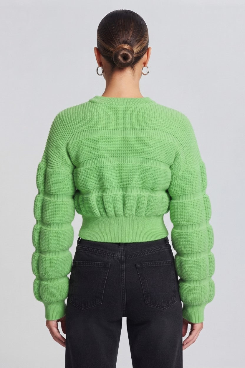 woman wearing a vibrant lime-green, textured knit sweater.