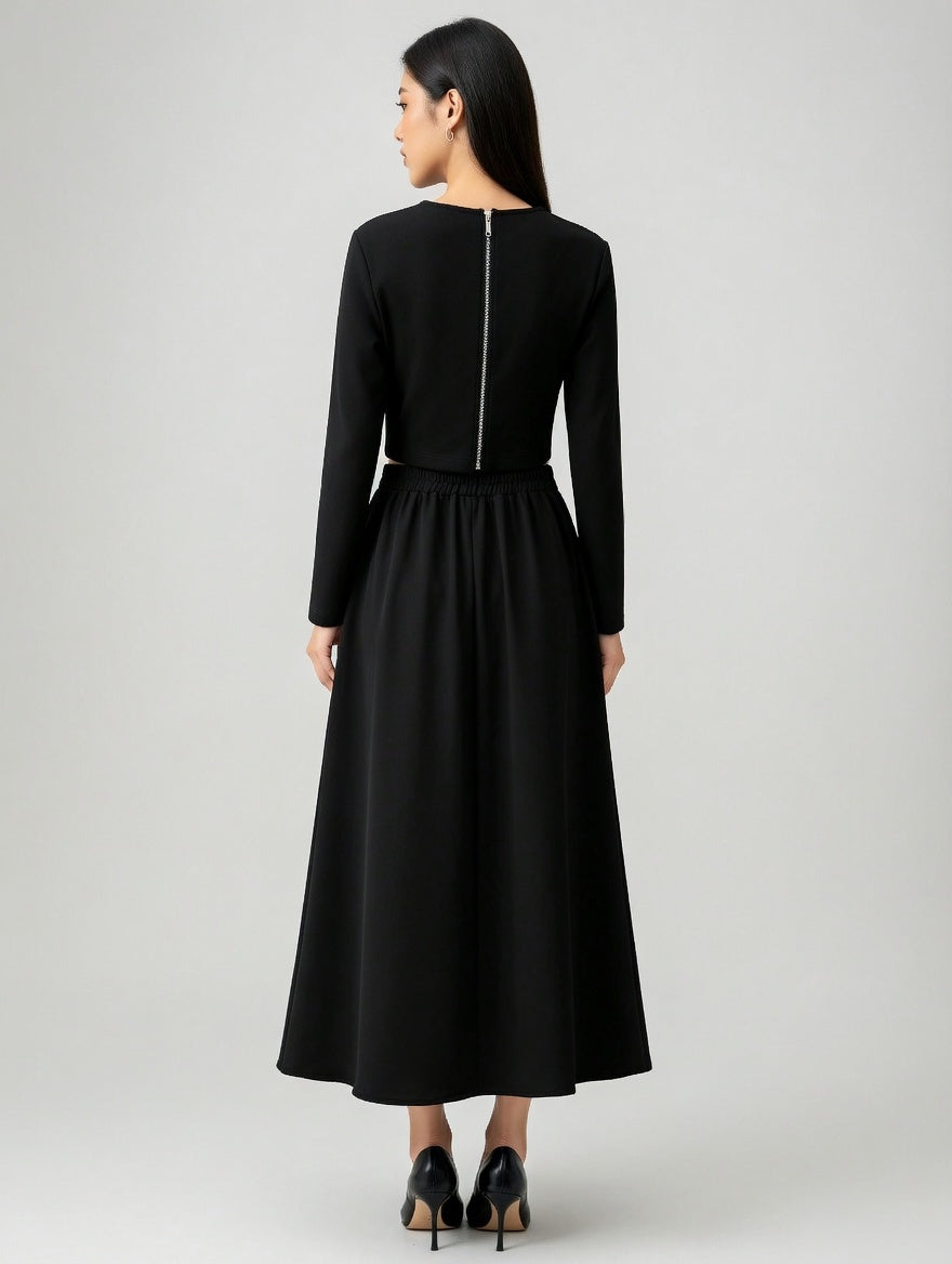 Woman wearing a black long-sleeve dress on a white background