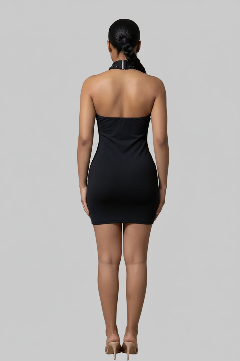 Woman wearing a black strapless dress against a plain background