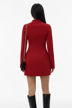 Woman in a red dress standing on a city street