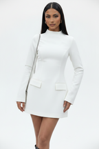Woman wearing a white dress with long sleeves on a white background