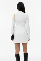 Person wearing a white dress with long sleeves on a white background