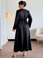 Woman wearing a black dress in an indoor setting