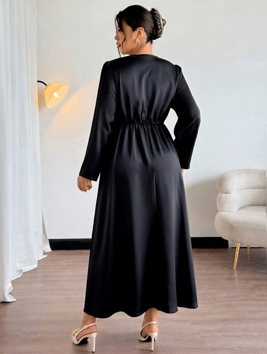 Woman wearing a black dress in an indoor setting