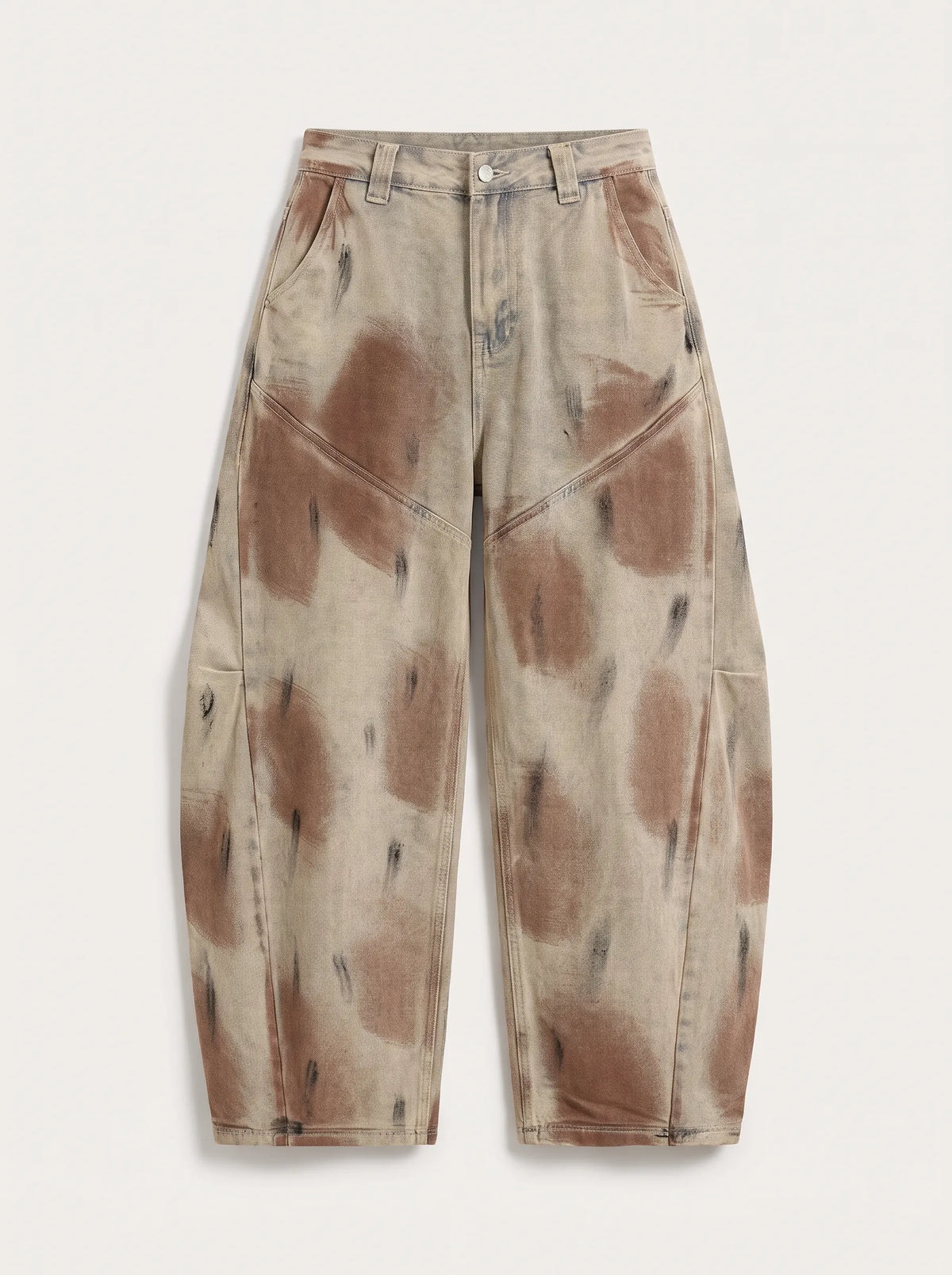 A  pair of high-waisted, curved barrel-leg jeans is crafted from a vintage-washed light khaki or beige denim adorned with an abstract, artistic spray-paint effect featuring mottled splotches of warm rust brown and distressed charcoal black.
