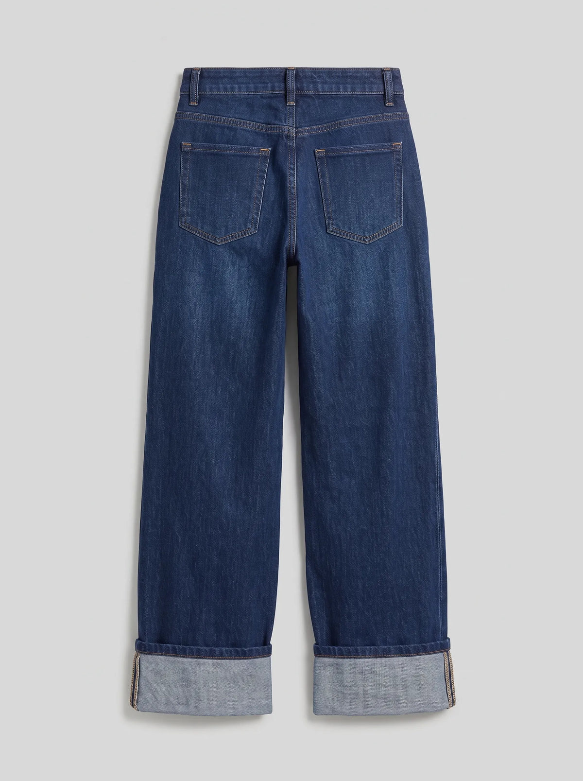 high-waisted dark blue wash wide-leg jeans featuring prominent wide turned-up cuffed hems. 