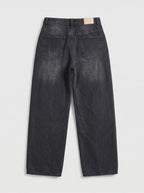 This pair of high-waisted, wide-leg jeans is crafted from a dark washed-black or washed-charcoal denim with subtle whiskering across the lap and gentle vertical fading down the legs.