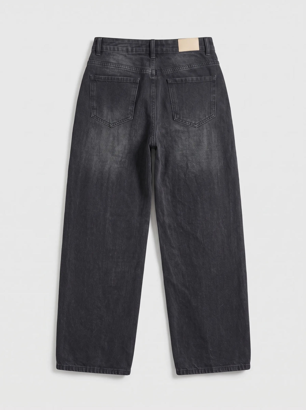 This pair of high-waisted, wide-leg jeans is crafted from a dark washed-black or washed-charcoal denim with subtle whiskering across the lap and gentle vertical fading down the legs.