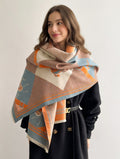 Woman wearing a patterned scarf on a plain background