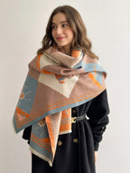 Woman wearing a patterned scarf on a plain background