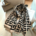 Black and white patterned scarf on a chair with a handbag in the background