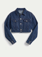 This is a deep indigo blue denim jacket features an ultra-cropped silhouette with long sleeves, tailored shoulder seams, and classic buttoned cuffs. It includes a traditional point collar and a full front placket detailed with smooth, metallic silver shank buttons.