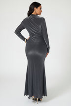 Woman wearing a long-sleeve, high-waisted gray dress on a white background