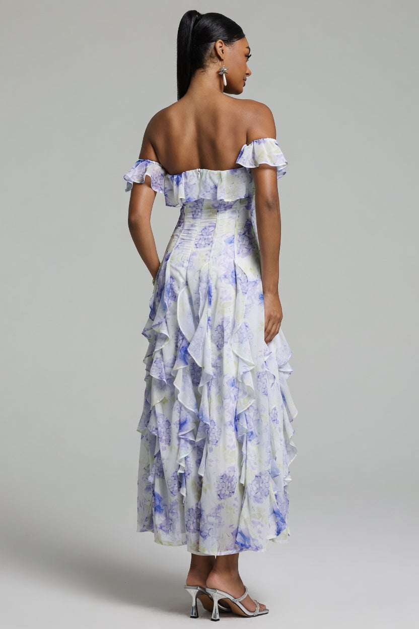 Woman wearing a floral off-shoulder dress against a gray background