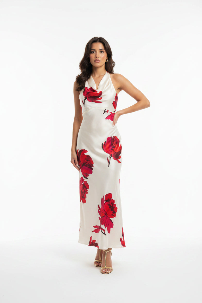 Woman wearing a white dress with red floral patterns on a white background