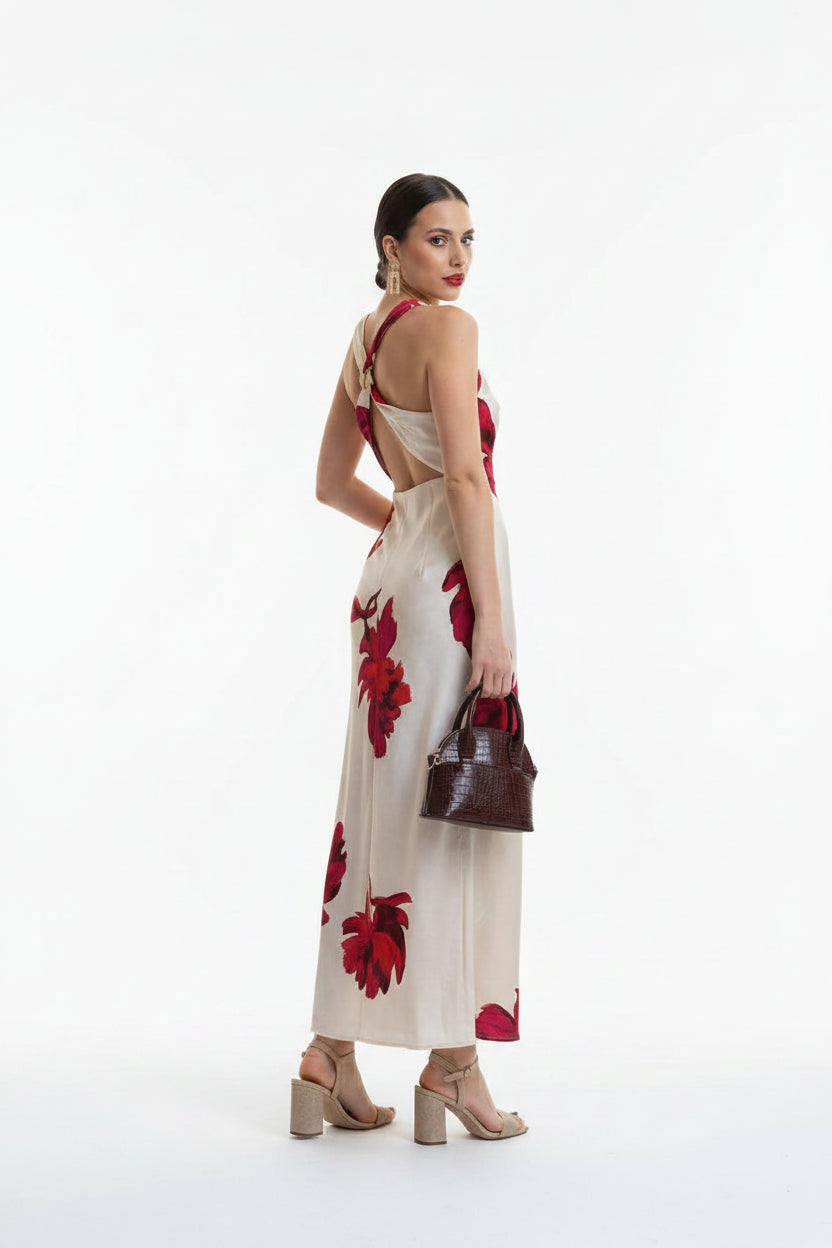 Woman wearing a white dress with red floral patterns on a white background