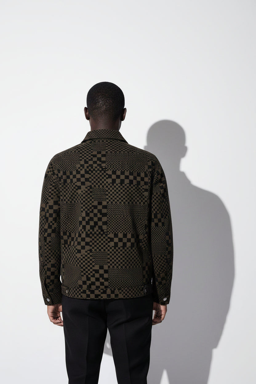 Person wearing a patterned jacket against a white background