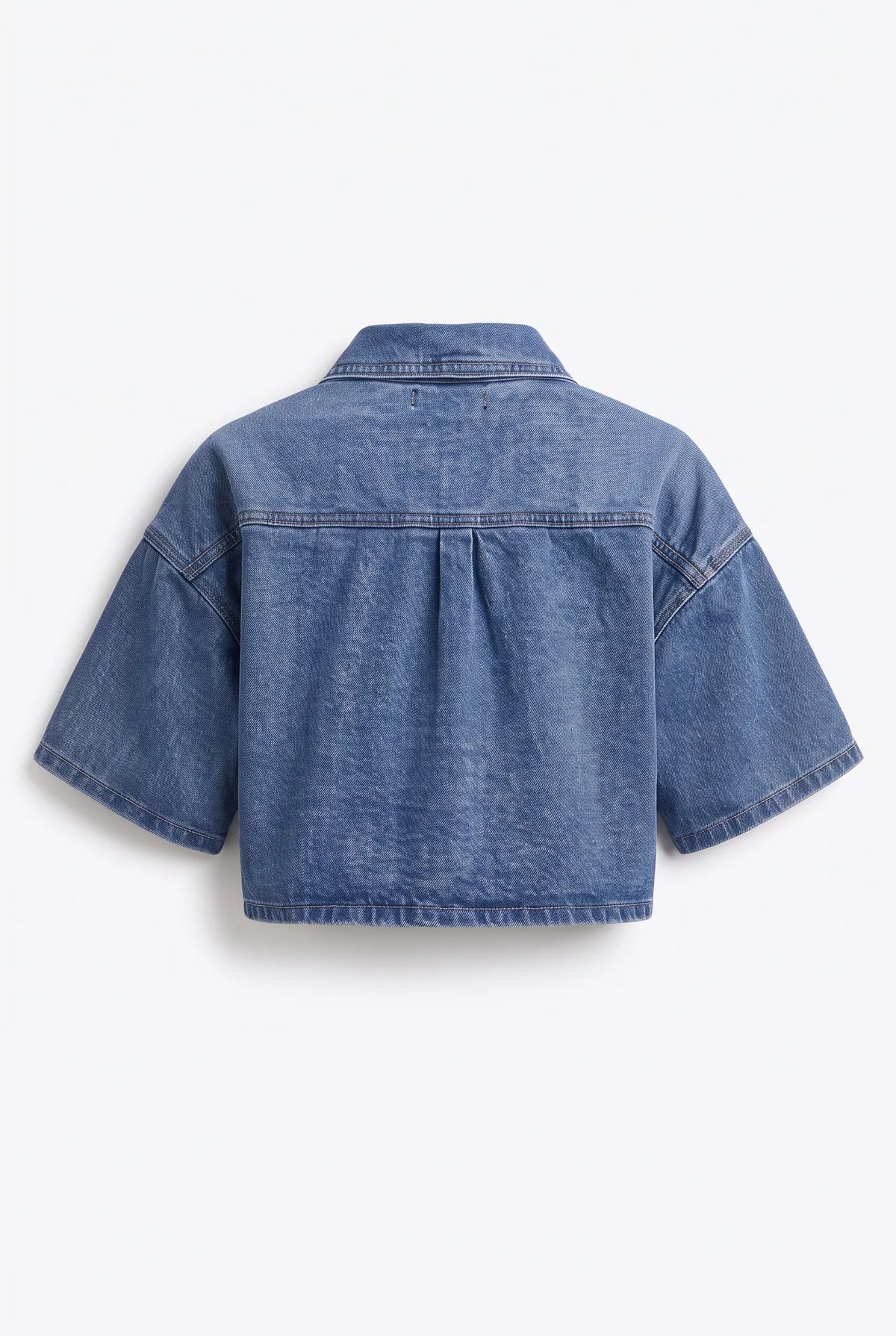 This is a medium-wash denim short-sleeved cropped jacket features a boxy, modern silhouette with relaxed drop shoulders and wide, elbow-length sleeves with stitched turned hems.
