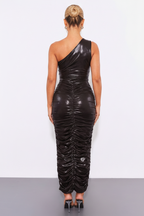 Black one-shoulder ruched dress worn by a model on a white background