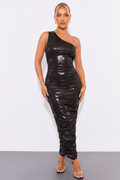 Woman wearing a black one-shoulder dress against a white background