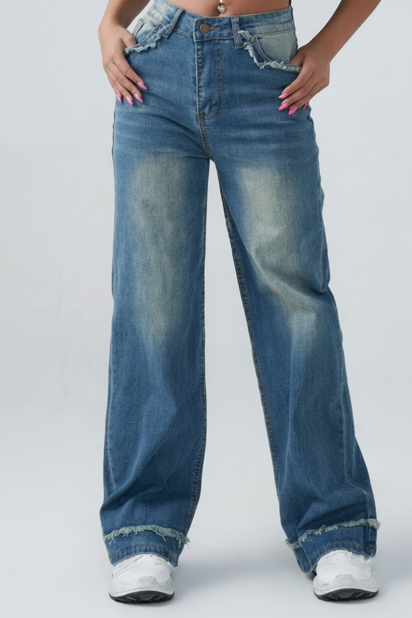 Person wearing blue jeans on a plain background