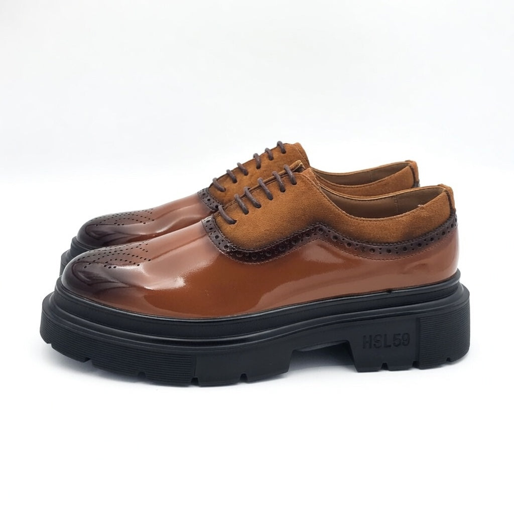 Brown leather shoes with thick black sole on a white background
