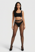 Woman wearing a black bikini and fishnet stockings on a white background