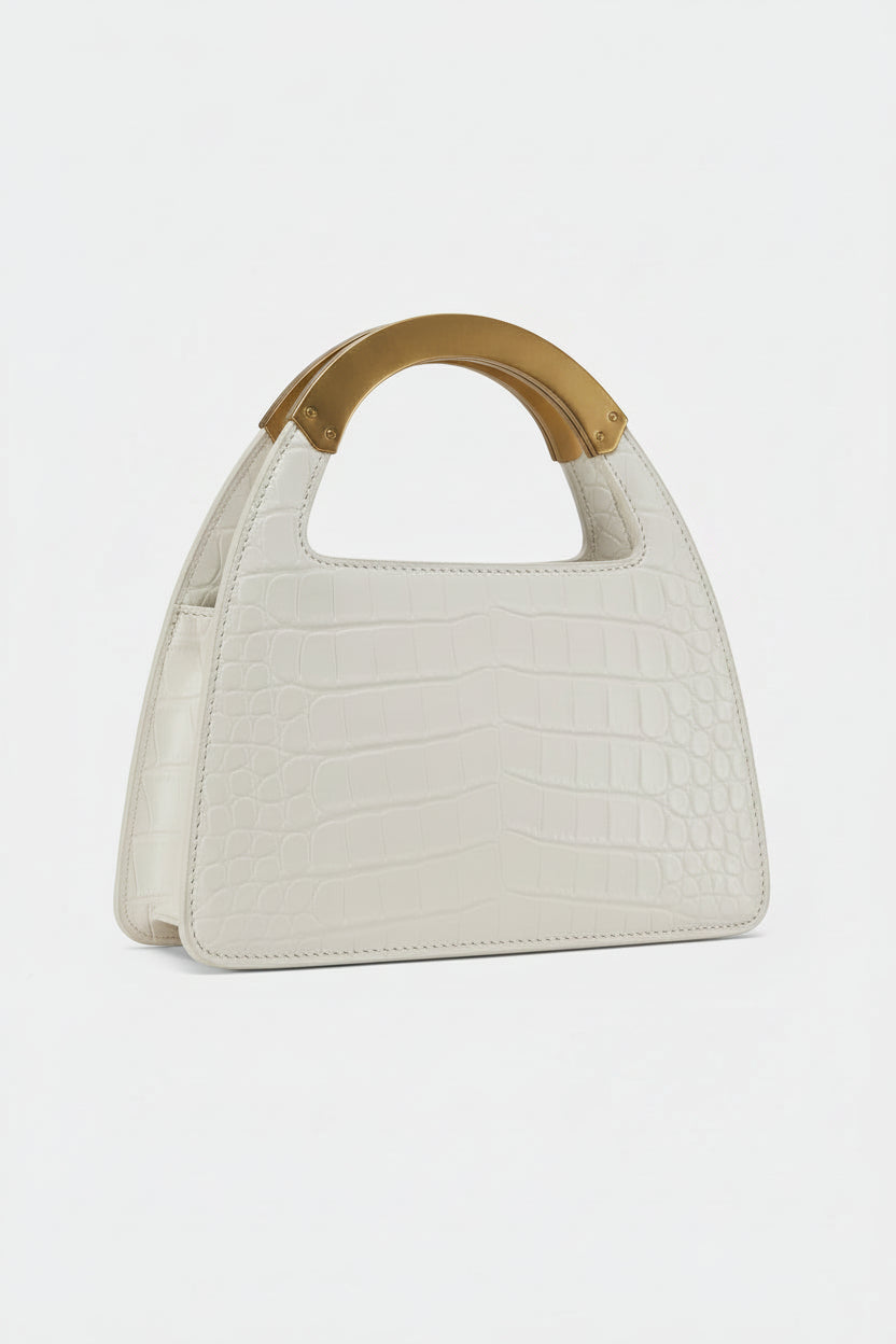 White handbag with a wooden handle on a light gray background