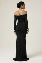 Woman wearing a black off-shoulder gown against a white background