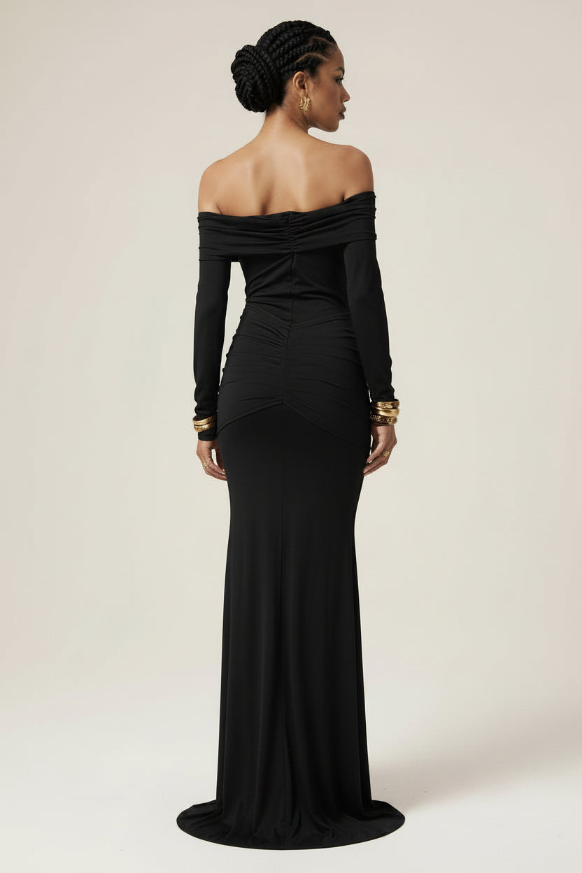 Woman wearing a black off-shoulder gown against a white background