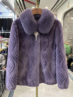 Purple textured fur coat with a fur collar on a hanger in a store setting.