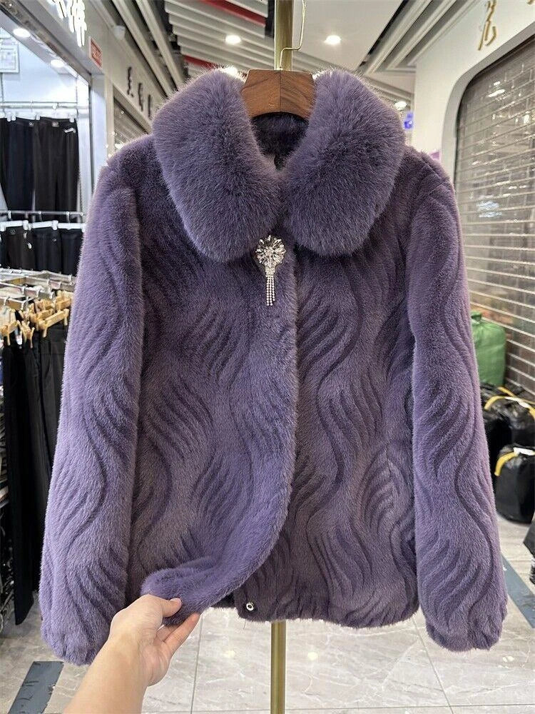 Purple textured coat with fur collar on a hanger in a store setting