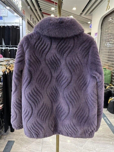 Purple textured coat on a mannequin in a store setting