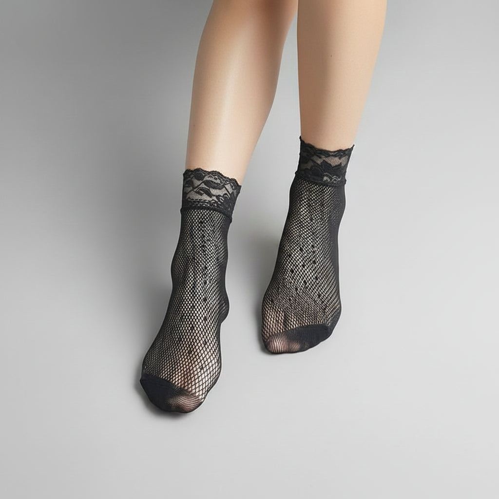 Black fishnet socks with lace top on a white background