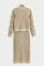 Beige ribbed knit dress on a hanger against a white background