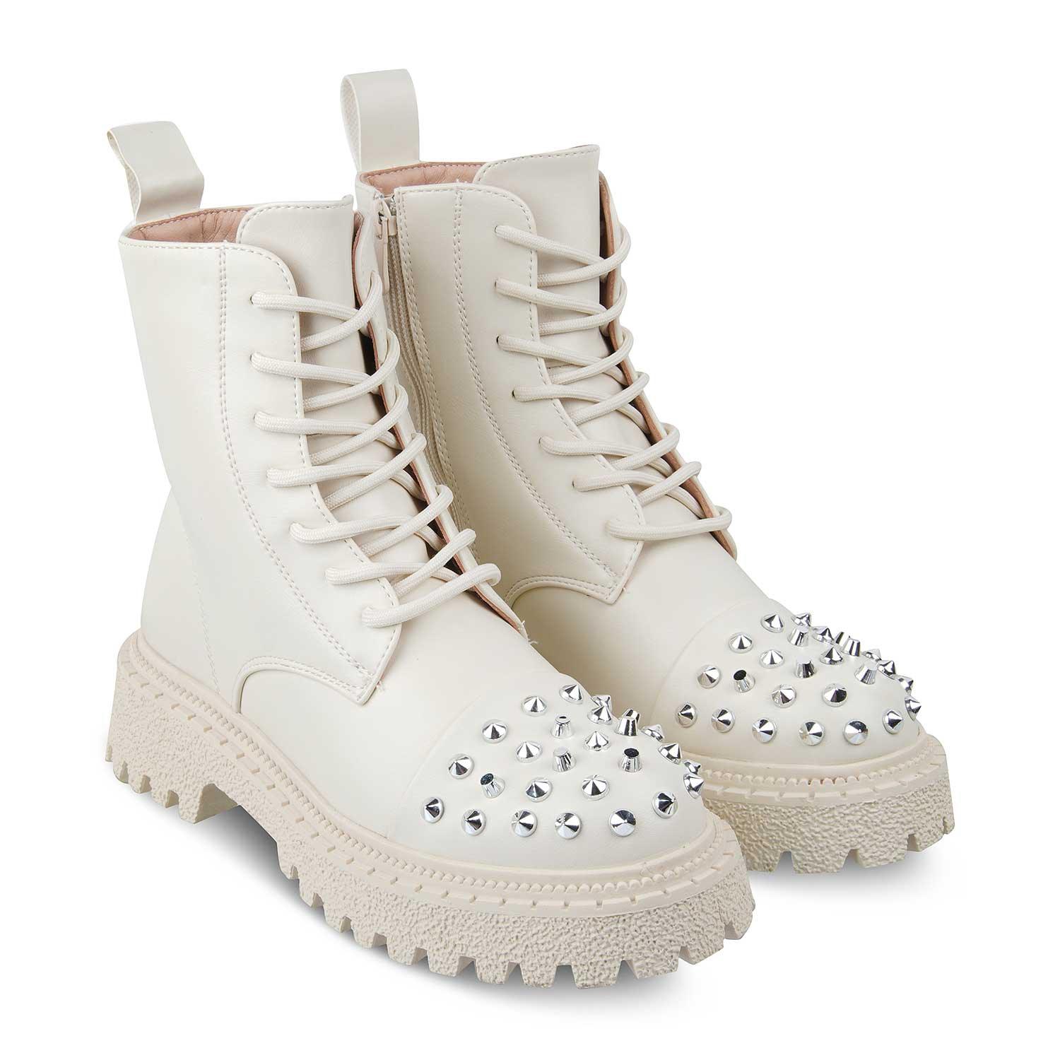 White combat boots with studded details on a white background