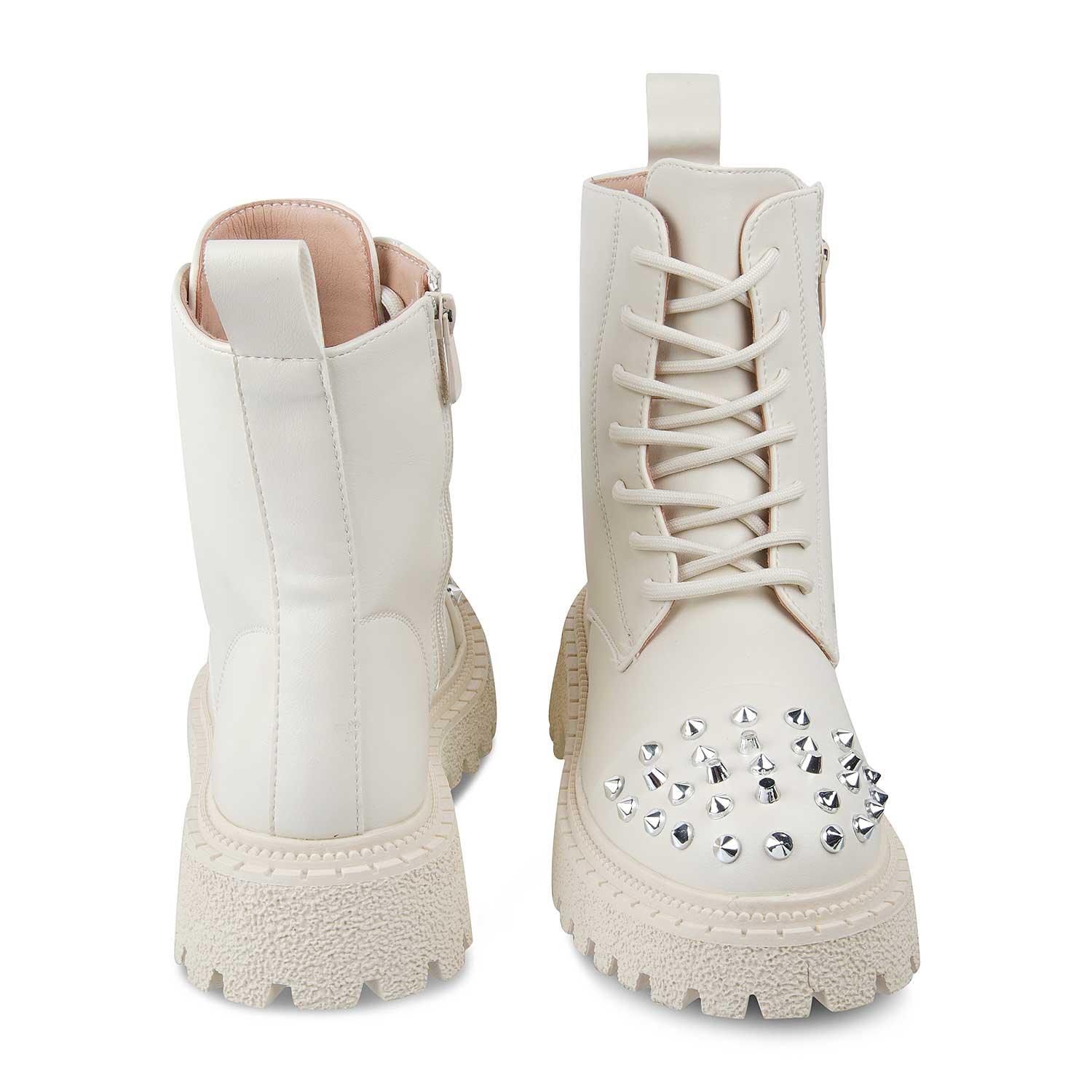 White combat boots with studded details on a white background