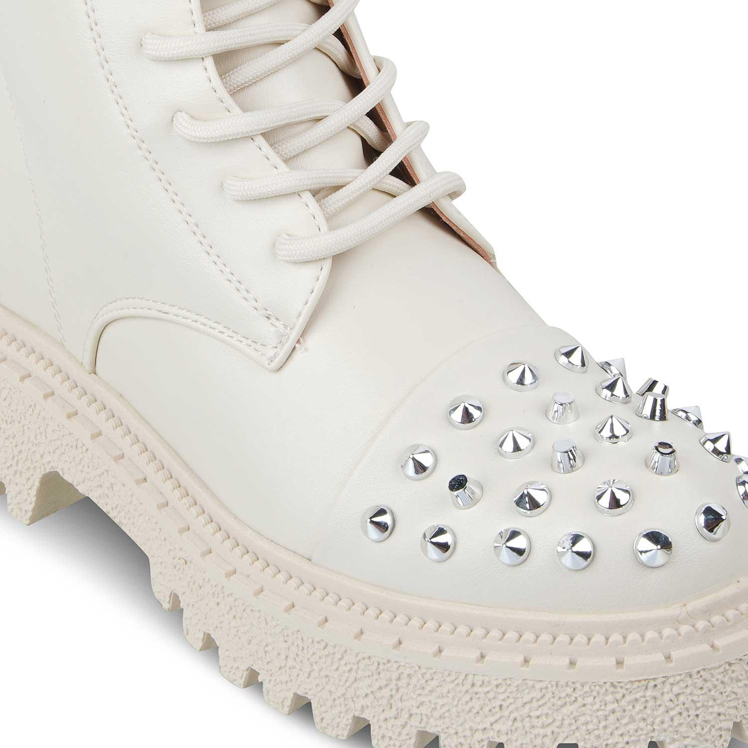 White boot with studded details on a white background