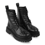 Black studded boots on a white background