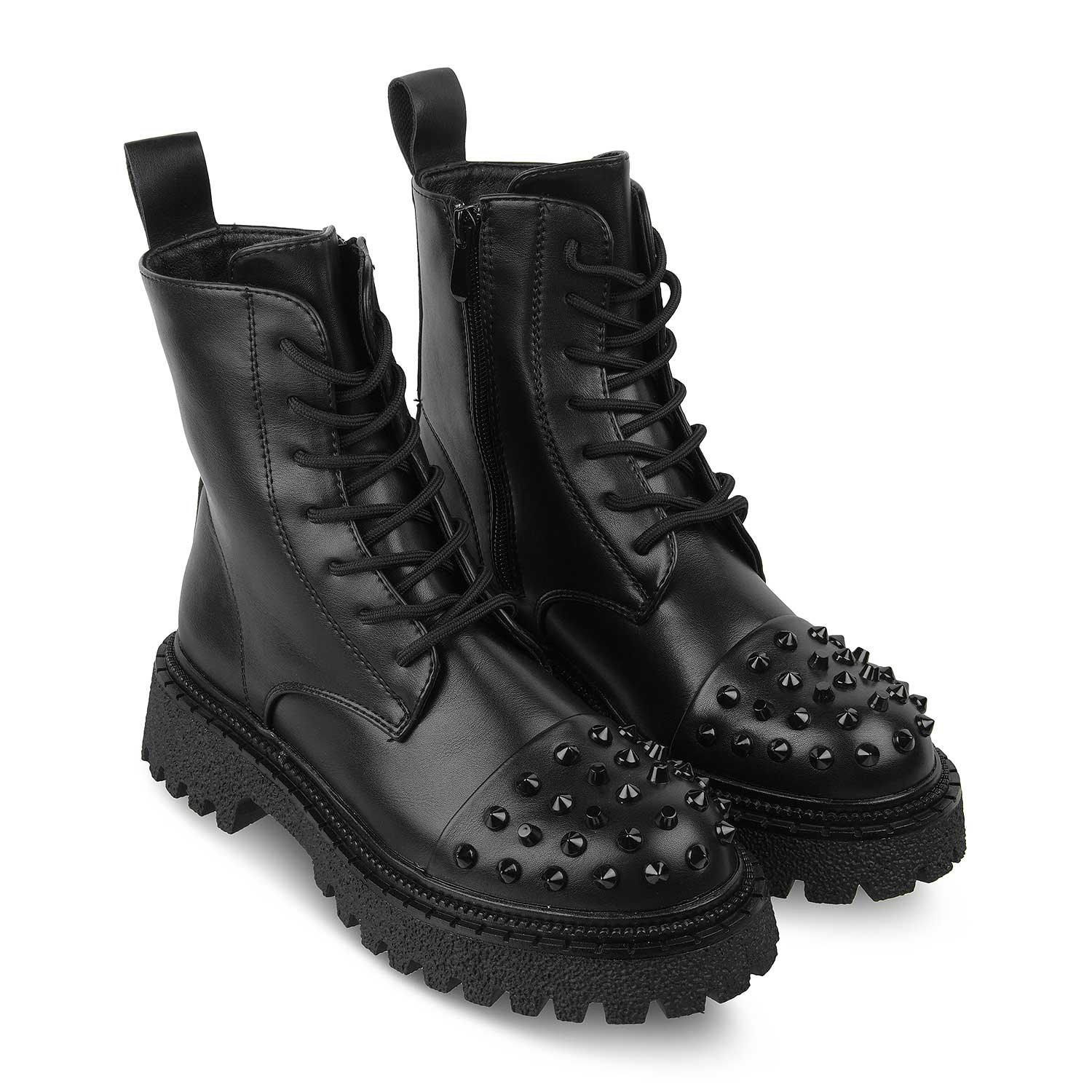 Black studded boots on a white background
