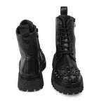 Black studded combat boots on a white background