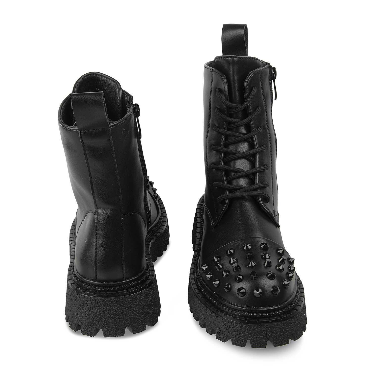Black studded combat boots on a white background