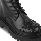 Black leather boot with studded details on a white background